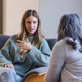 The young adult female talks to the counselor about relationship issues she is having.